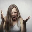 Woman screaming with hands inthe air