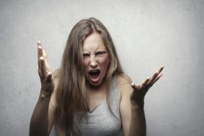 Woman screaming with hands inthe air