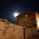 Moon over brick wall & brick building