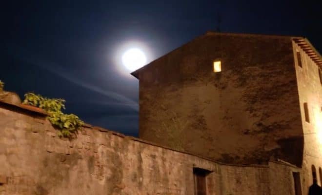 Moon over brick wall & brick building