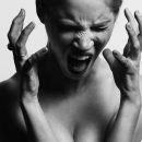 Woman screaming with her hands open near her face