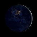 A dark picture of the earth. There's a sliver of an outline to the right and the US can be see with lights on