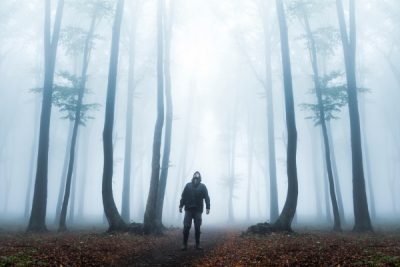 Foggy forest, hooded man
