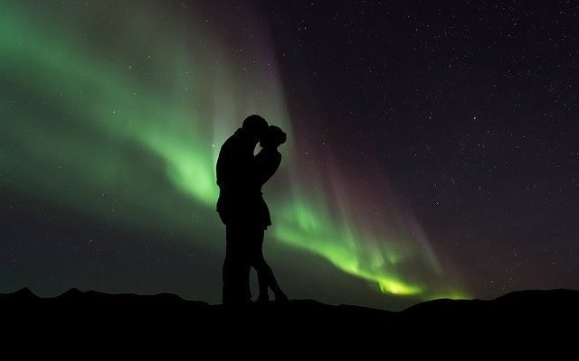 Couple with borealis behind them