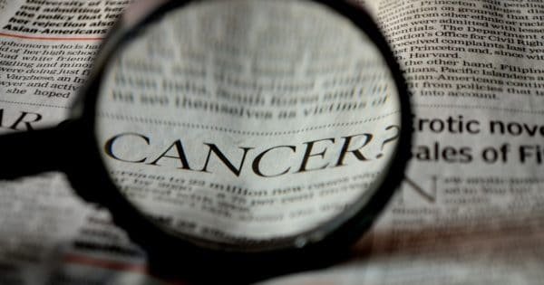 newspaper with the word cancer magnified
