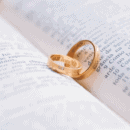 two wedding rings lying on a book