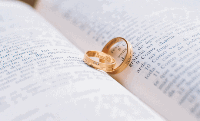 two wedding rings lying on a book