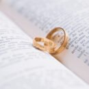 two wedding rings lying on a book