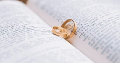 two wedding rings lying on a book