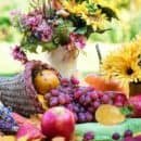 Image of an autumn cornucopia full of fruits and decorated with flowers. Cornucopia is a sweet fantasy poem about an animal Thanksgiving.