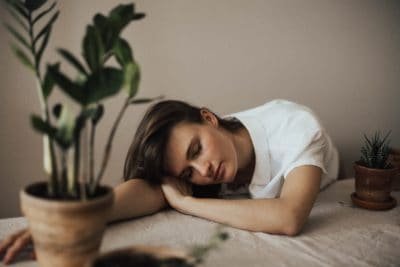 woman lying on table asleep