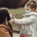 parent and child wearing masks outdoors