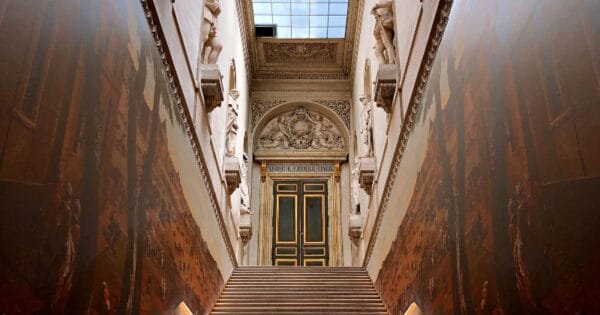 feature-image-a-set-of-wooden-stairs leading up to a marble door