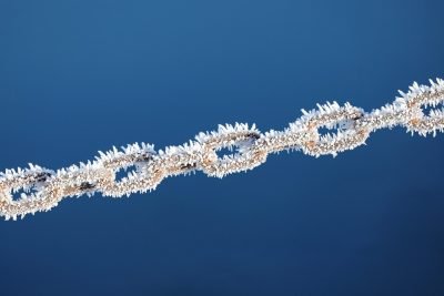 Chain with frozen ice on a blue background