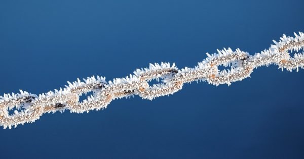 Chain with frozen ice on a blue background