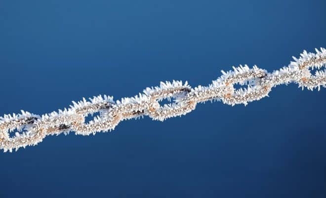 Chain with frozen ice on a blue background