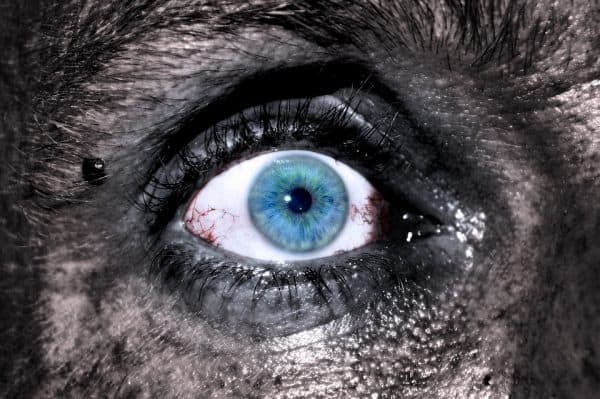 Image of a young woman's blue eye with dirt on her skin by Adrian courtesy of Pixabay is the cover image for Scarlett Faye's young adult serial story about Micki, a teenager fighting for survival after being in a gruesome wreck with her mother.