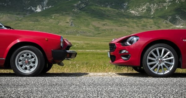 two red cars face each other