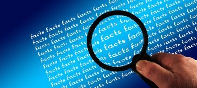 magnifying glass over the word facts