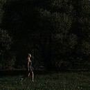 woman walking through forest alone