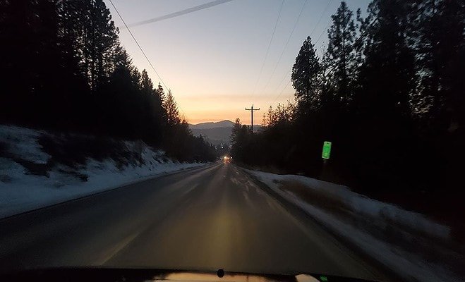 Image of a dark road at sunset in northern Idaho.