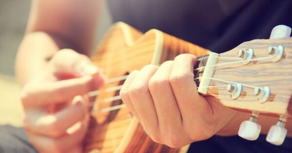 hands playing a ukulele