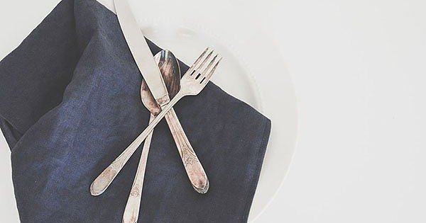 A place setting with the fork and knife crossed