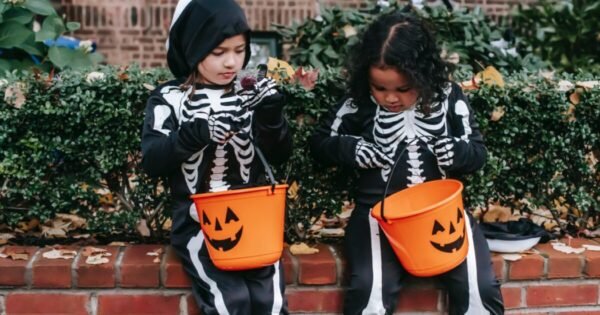 two children dressed as Halloween skeletons