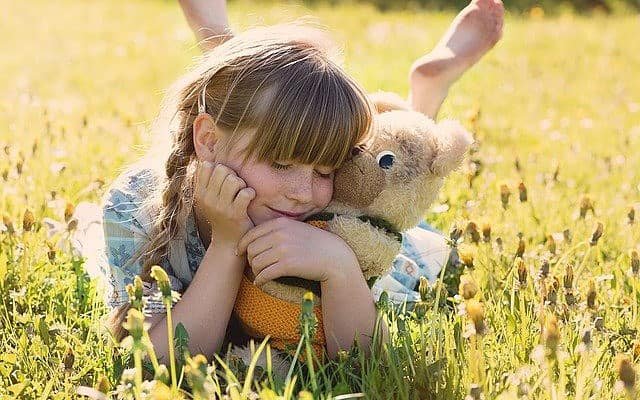 Girl embracing a teddy bear