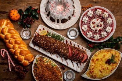 A Christmas table featuring bread, peppermint, string casserole, roast, pie cake, pinecones, holy berries and mac and cheese.