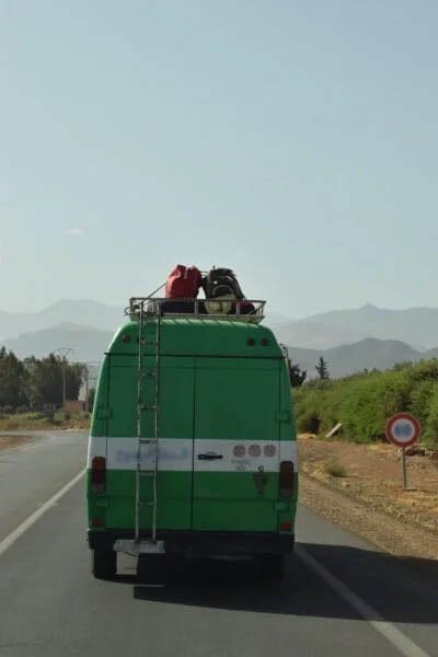 A bus with luggage on top