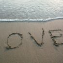 Word LOVE written in Sand