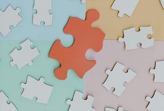 white puzzle on colored background