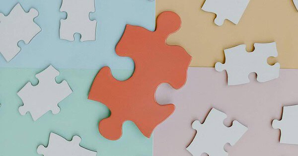 white puzzle on colored background