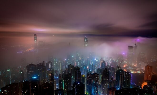 Clouds cascading upon a city at night