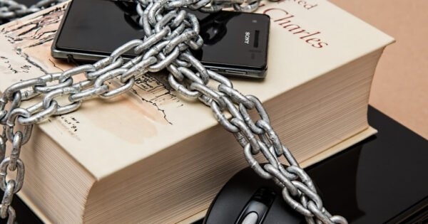 A book and laptop chained together