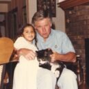 Tara, UJ, and the cat Toot posing for the picture by the fire place.