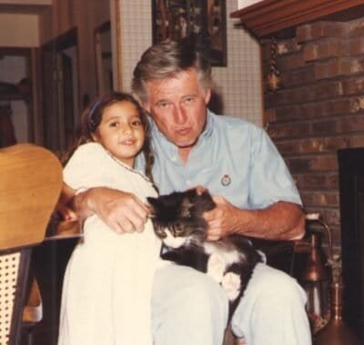 Tara, UJ, and the cat Toot posing for the picture by the fire place.