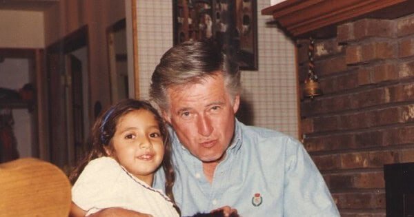 Tara, UJ, and the cat Toot posing for the picture by the fire place.