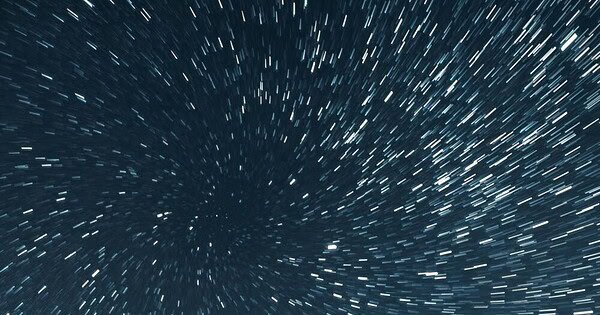 Stars trails along the periphery blur against the dark background of deep space creating a cosmic tunnel to travel through.