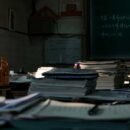 Stacks of books and notebooks on a table