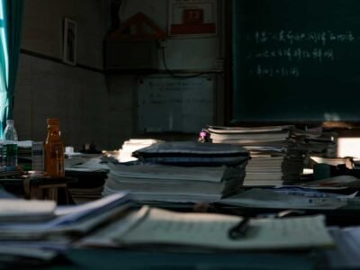 Stacks of books and notebooks on a table