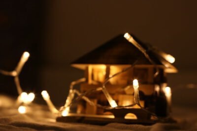 A dollhouse lit by a white string of lights