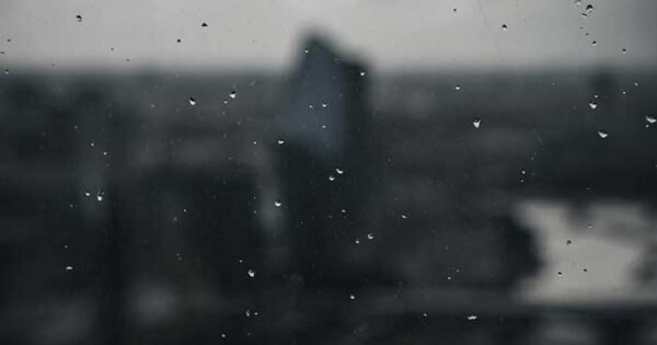 A blurred black and white photo of a person on a beach