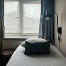 a room with a bed close to the window