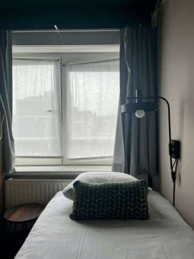 a room with a bed close to the window