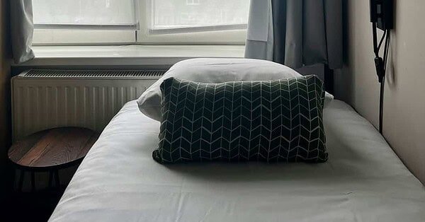 a room with a bed close to the window