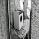 Gray stone walled doorway with a single dryer when you enter the room.