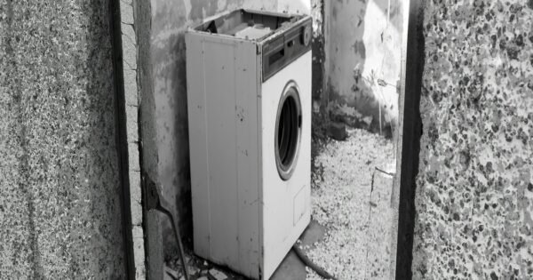 Gray stone walled doorway with a single dryer when you enter the room.