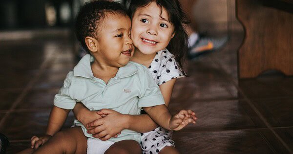 Two small children hugging